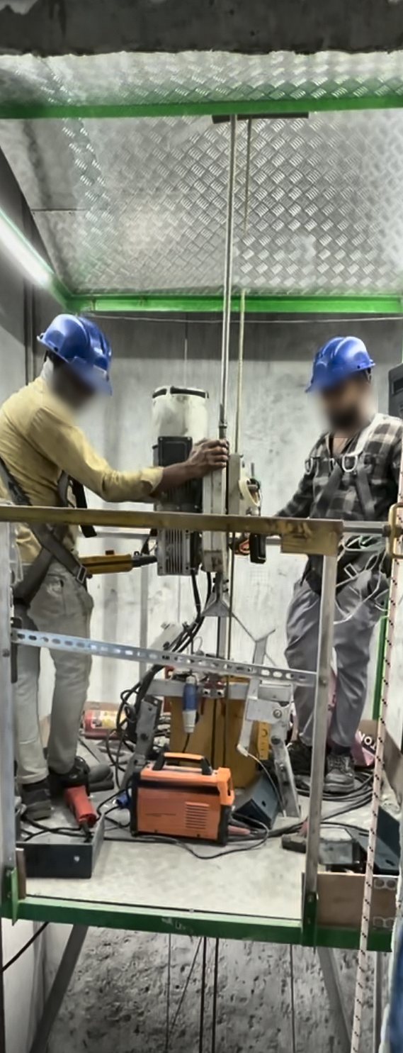 False car with overhead protective canopy and installers at work